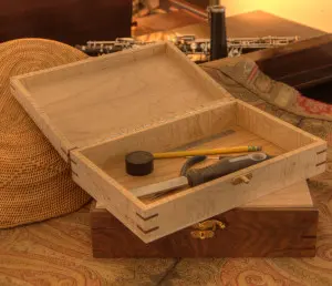 A Hand-Crafted Tool Boxes with tools in it.