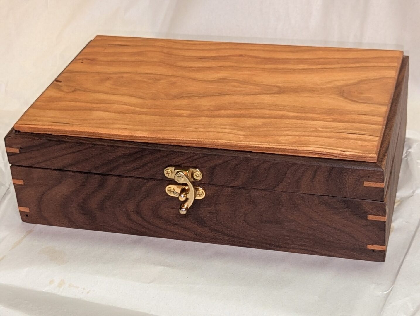 A sturdy handmade wooden box, perfect for storing away supplies on your reed desk.