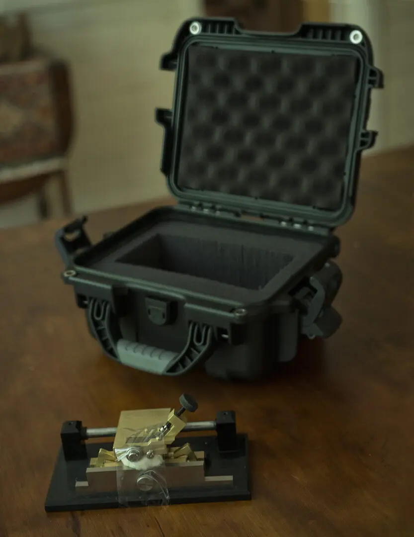 A black case with a small tool on top of it.