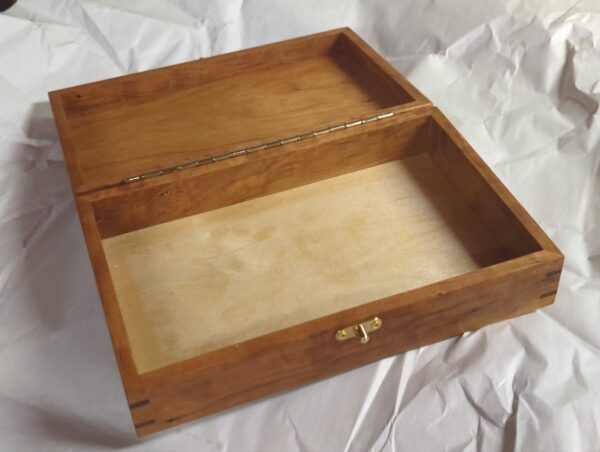 A small Hand-Crafted Tool Box with a lid on it.