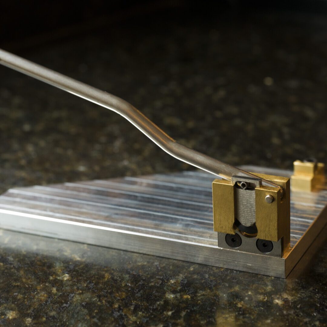 A small piece of guillotine metal on a countertop.